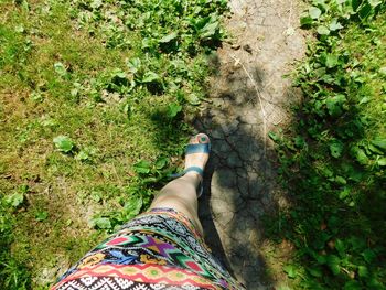 Low section of person relaxing on land