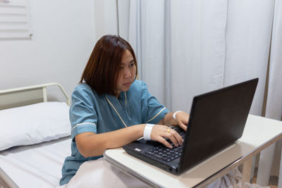 Young woman using mobile phone at home