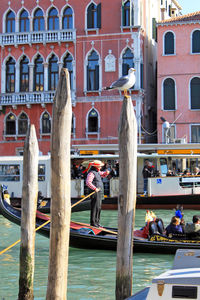 People in boat on canal in city