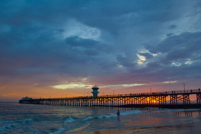 Scenic view of beach against sky during sunset