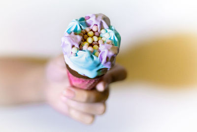 Close-up of multi colored icecream in hand