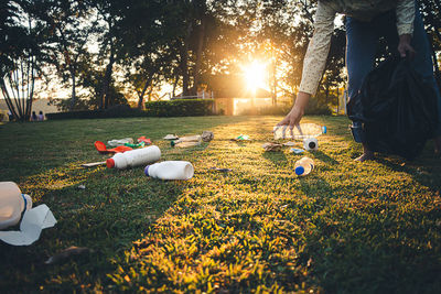 Low section of people relaxing on field in park