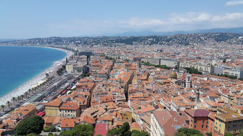 High angle view of townscape by sea against sky