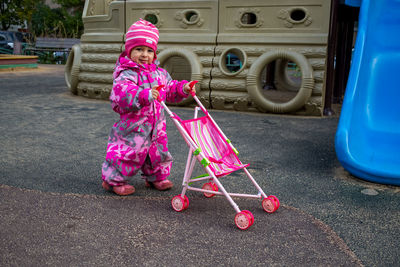 Full length of boy playing with toys on road