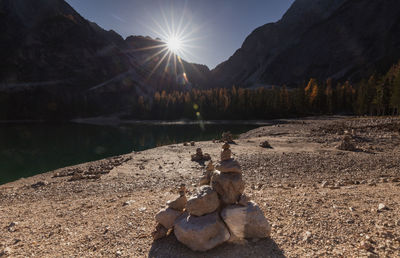 Scenic view of rocks by lake against sky