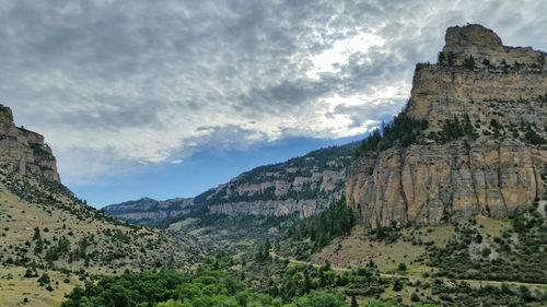 Low angle view of rocky mountain against sky