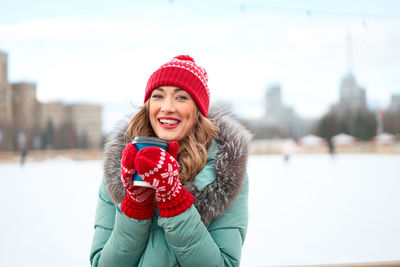 Portrait of a smiling young woman in snow