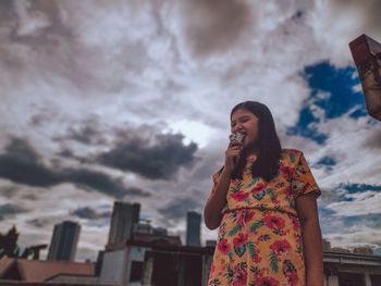 Woman standing against sky