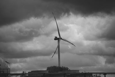 Low angle view of windmill against sky