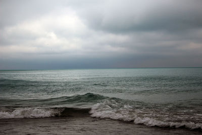 Scenic view of sea against cloudy sky