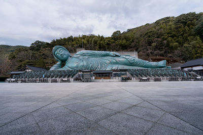 Statue of building against cloudy sky