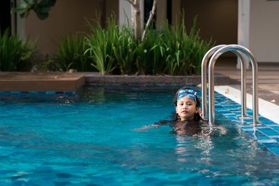 Portrait of boy swimming in pool