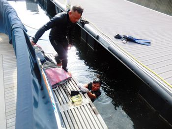 High angle view of men on boat in canal