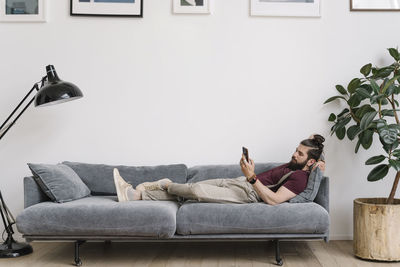 Man sitting on sofa at home