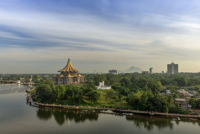 River amidst buildings against sky