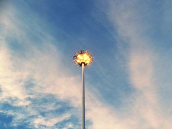 Low angle view of street light against blue sky