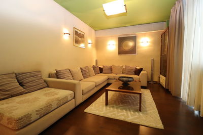 Empty chairs and tables in illuminated room at home