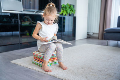 Portrait of cute girl playing with toys at home