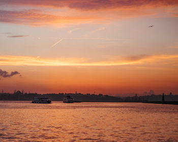 Scenic view of sea against orange sky