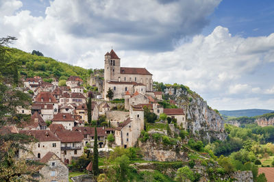 Old buildings in town against sky