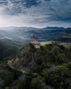 Scenic view of mountain against cloudy sky