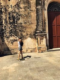 Woman standing against building