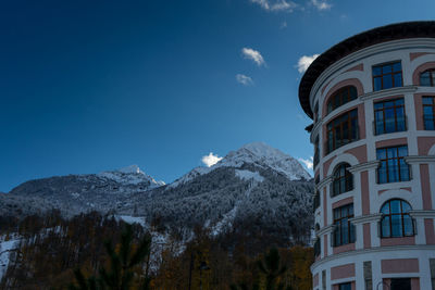 Low angle view of buildings against blue sky