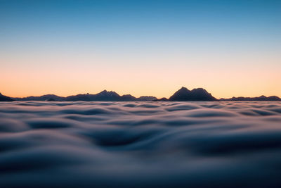 Scenic view of sea against clear sky during sunset