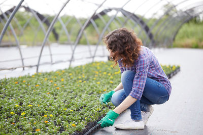 Smiling woman working in botanical garden