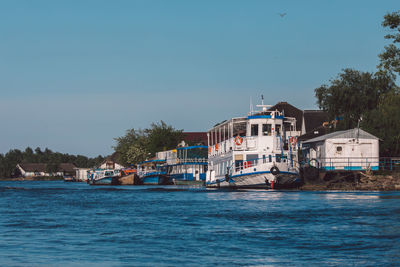 View of buildings by sea against sky