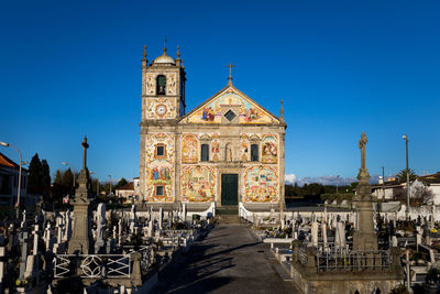 Facade of church against clear blue sky