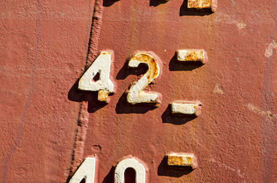 Close-up of the draught marks on a weathered ship's hull, focussing on the number 42