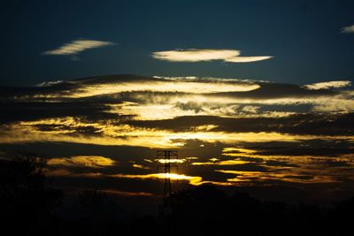 Silhouette trees against sky during sunset