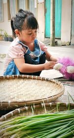 Side view of cute boy playing on table