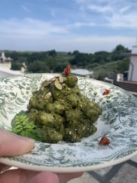 Close-up of hand holding ice cream cone