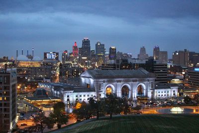 Illuminated buildings in city at dusk