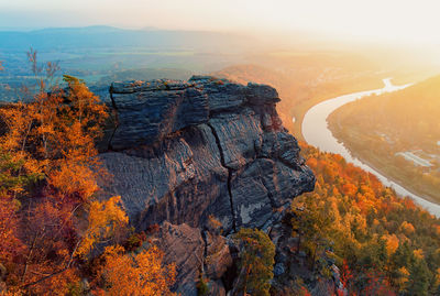 Scenic view of rocky mountain and autumn trees during sunset at saxon switzerland national park