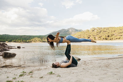 Young women doing acroyoga