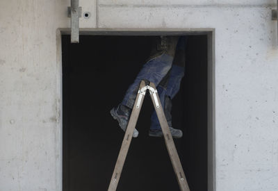 Man working on broken window of building