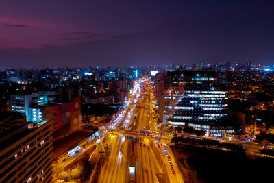 Illuminated cityscape against sky at night