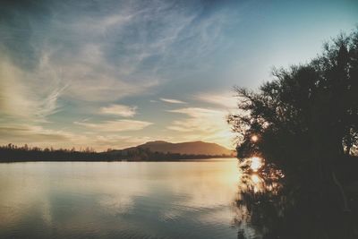 Scenic view of lake against cloudy sky