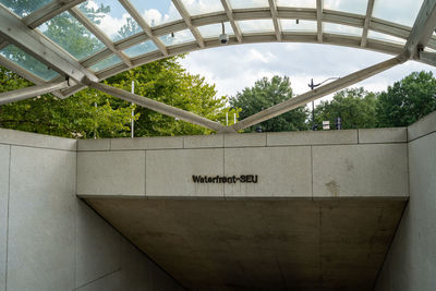 Low angle view of text on bridge against sky