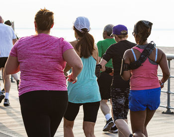 Rear view of people standing in water