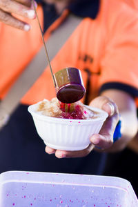 Midsection of person holding ice cream