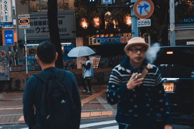 Friends standing on street in city