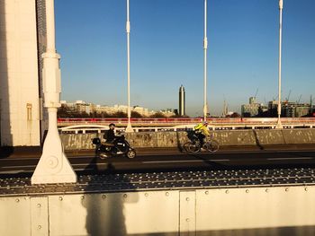 Cars on bridge against clear sky