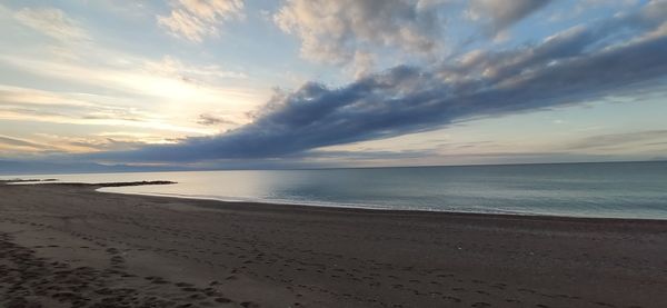 Scenic view of beach against sky during sunset