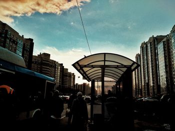 Buildings in city against cloudy sky