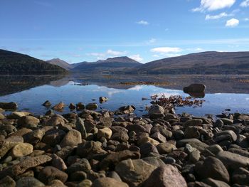 Scenic view of lake and rocks against clear sky