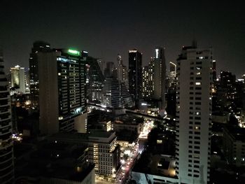 High angle view of illuminated buildings against sky at night